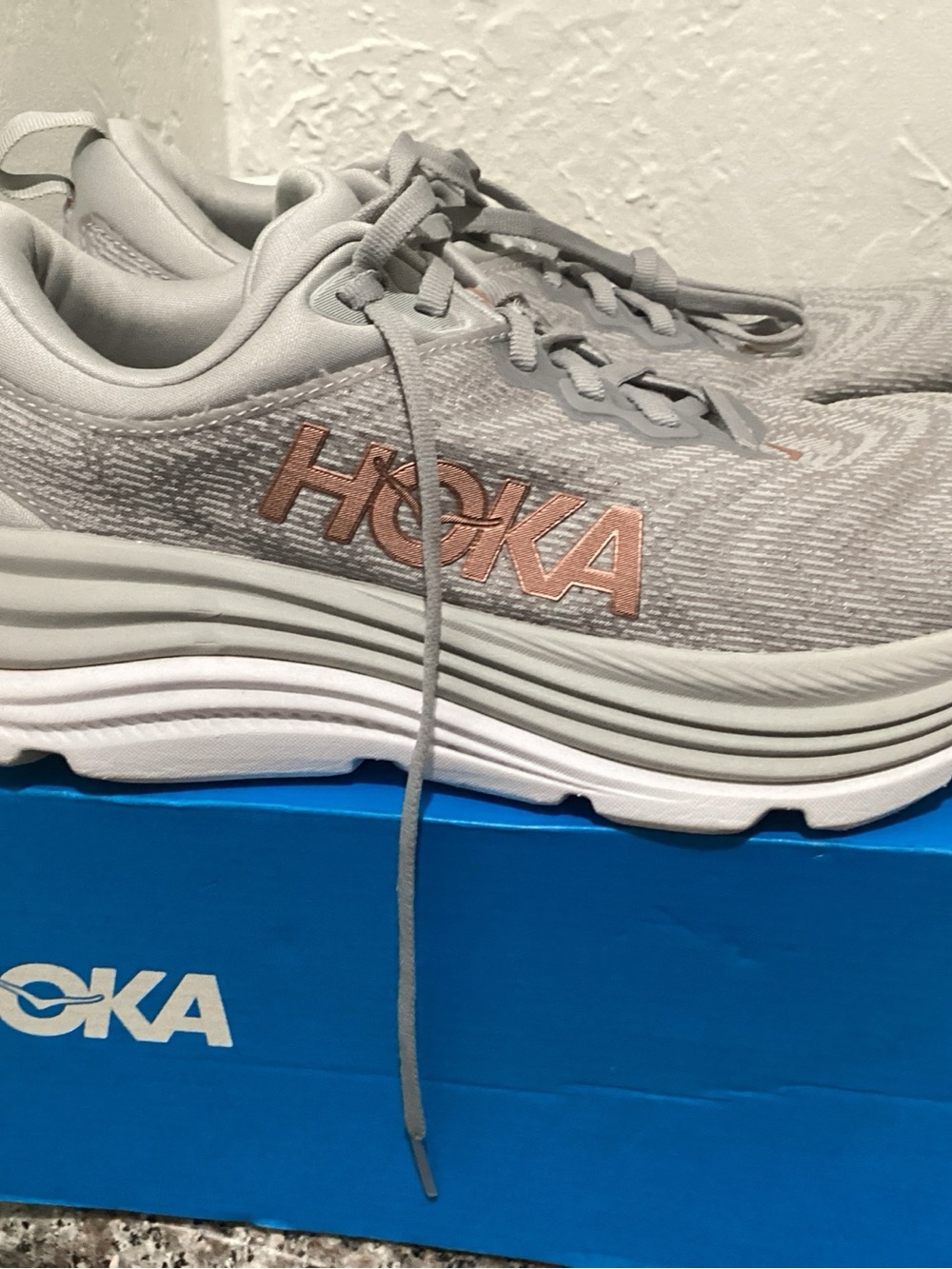 Hoka One One White Athletic Shoe with Blue Logo